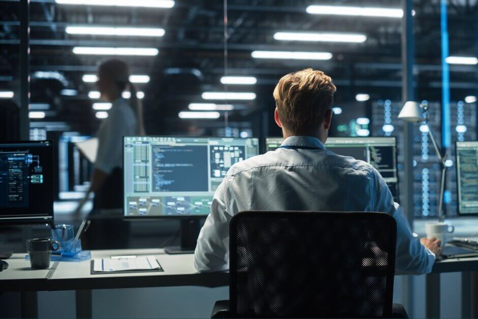 cyber security consultant working behind it security desk